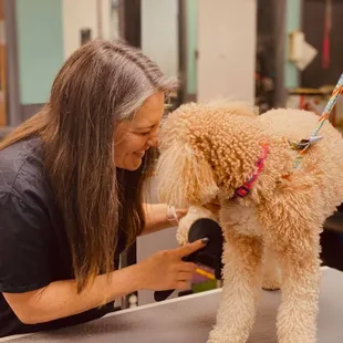 Carrie, our grooming manager, snuggling one of her clients!