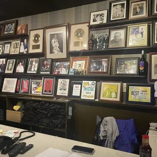 a wall of framed photos