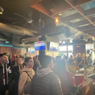 a crowd of people at a bar