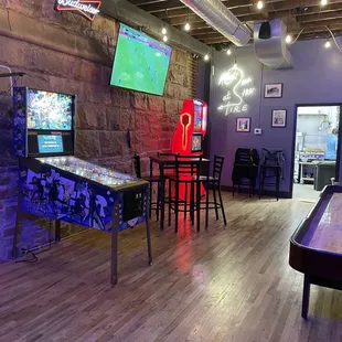 a pinball table in a game room