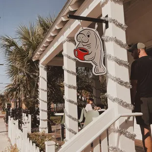 a man standing outside of a restaurant