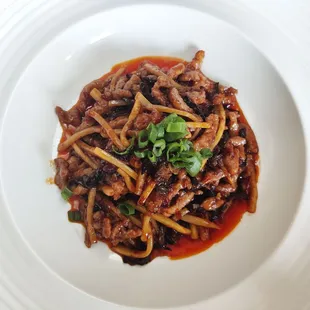 a plate of food with noodles and meat