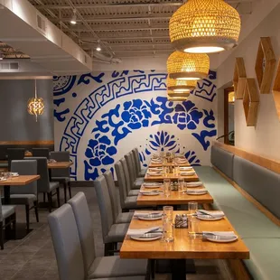 a dining room with blue and white wallpaper