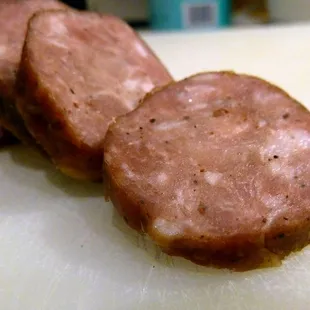 three sausages on a cutting board