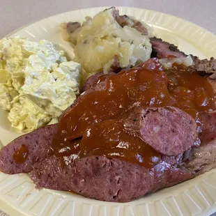 Brisket &amp; sausage plate with potato salad and buttery potatoes.