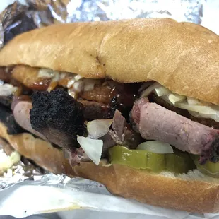 The Longhorn Hoagie: brisket sandwich with onion rings, onions, pickles, and hot BBQ sauce