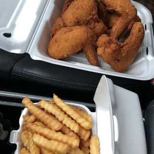 fried chicken and fries in a styrofoam container