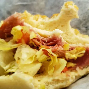 a sandwich with meat and lettuce