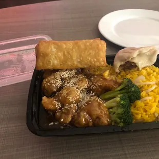 Sesame chicken combination platter with a side of pork Fried Dumpling