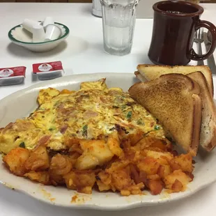 Today's special - super omelette: bacon, sausage, ham, green peppers, tomatoes, mushrooms, onions &amp; cheese w/ homefries &amp; toast