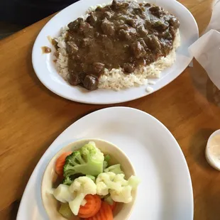 Beef tips over rice and mixed veggies