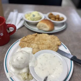 Chicken Fried Steak Lunch with mash potatoes, fried okra, and potato salad.