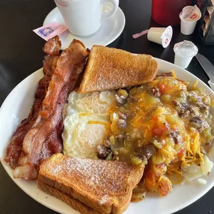 Bacon and eggs, home fries smothered with green chili.