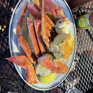 a plate of crab legs and potatoes