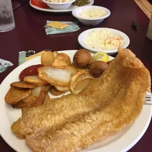 Catfish, fried potatoes, hush puppies and slaw