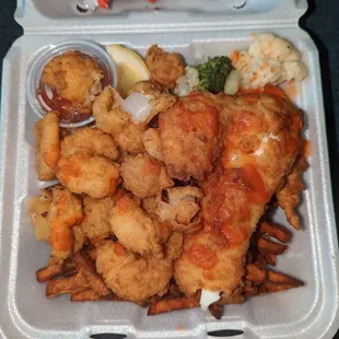 Seafood platter with sweet potato fries and mixed vegetables