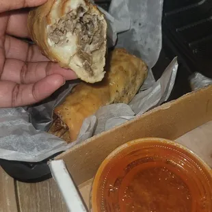 Cheesesteak rolls with spicy ketchup sauce to dip