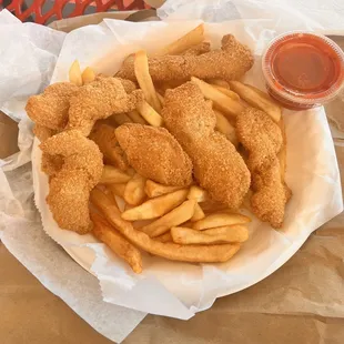 a basket of fried fish and fries