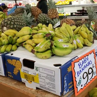 a display of bananas and pineapples