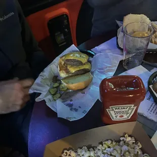 a burger and a box of popcorn