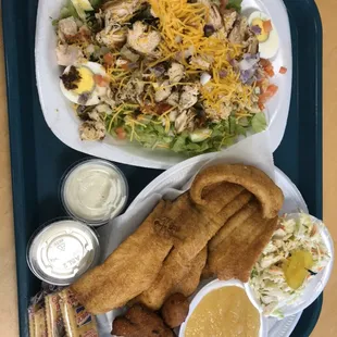 Here we have our Grilled Chicken Salad plate and our Fillet Flounder Plate with Cole slaw and apple sauce along side of hush puppies.