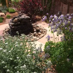a fountain surrounded by flowers