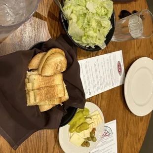 a table with a sandwich and salad
