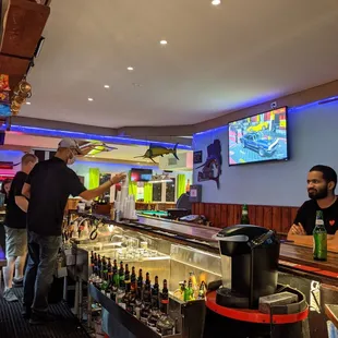 a bar with people at the bar