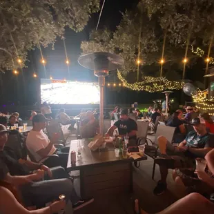 a crowd of people sitting around a bar