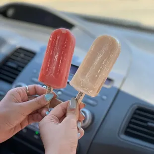 a person holding a popsicle