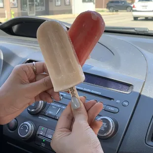 a person holding a popsicle