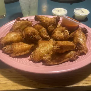 a plate of chicken wings and fries