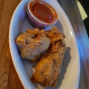 a plate of fried chicken with ketchup