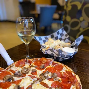 a pizza and a glass of wine