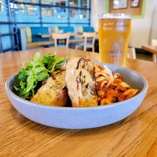 a plate of food and a glass of beer