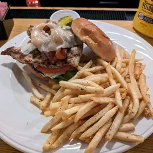 Chicken sandwich with bacon and cheese with fries