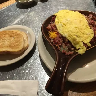 Sourdough toast with a hefty plate of corned beef hash &amp; eggs