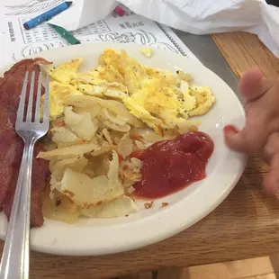 Kids plate eggs, potatoes, and bacon