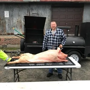 a man cutting a pig