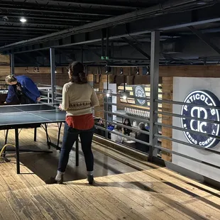 a woman playing ping pong