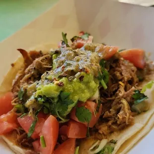 Carnitas taco add Guacamole and Tomato