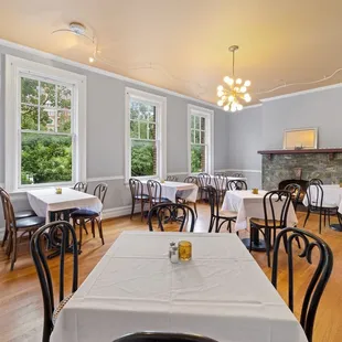 tables and chairs with white tablecloths