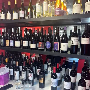 a shelf full of wine bottles