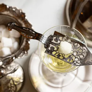 Absinthe, Paris' favorite drink, served with a water drip on a silver "green fairy" statue.