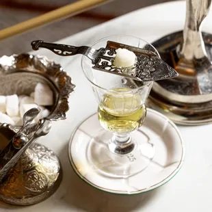 Absinthe, Paris' favorite drink, served with a water drip on a silver "green fairy" statue.
