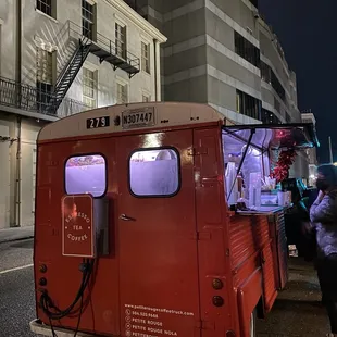  red food truck parked on the side of the road