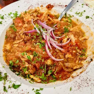 a plate of food with a fork and spoon