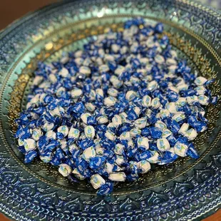 a bowl of blue and white flowers