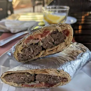Kufta Kebab sandwich $9 with hummus, tomato and onion