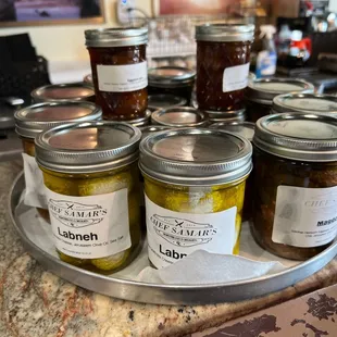 a tray of jars of jams on a counter